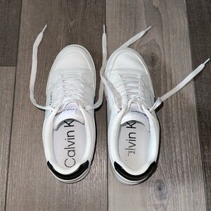 White clean look Calvin Klein sneakers.